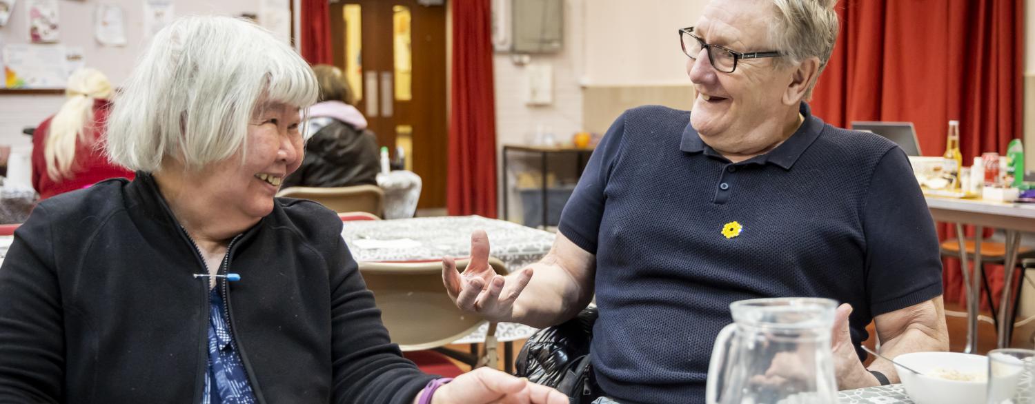 Man and woman at table in day centre